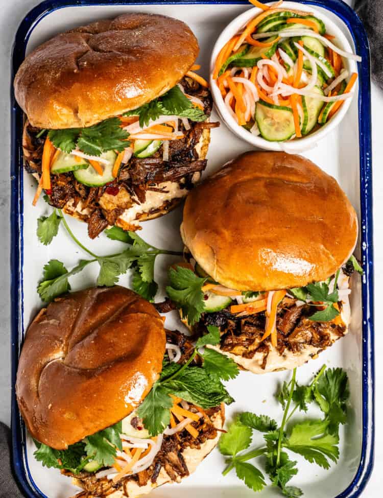 Looking down on three Korean Pulled Pork Sandwich on a serving tray
