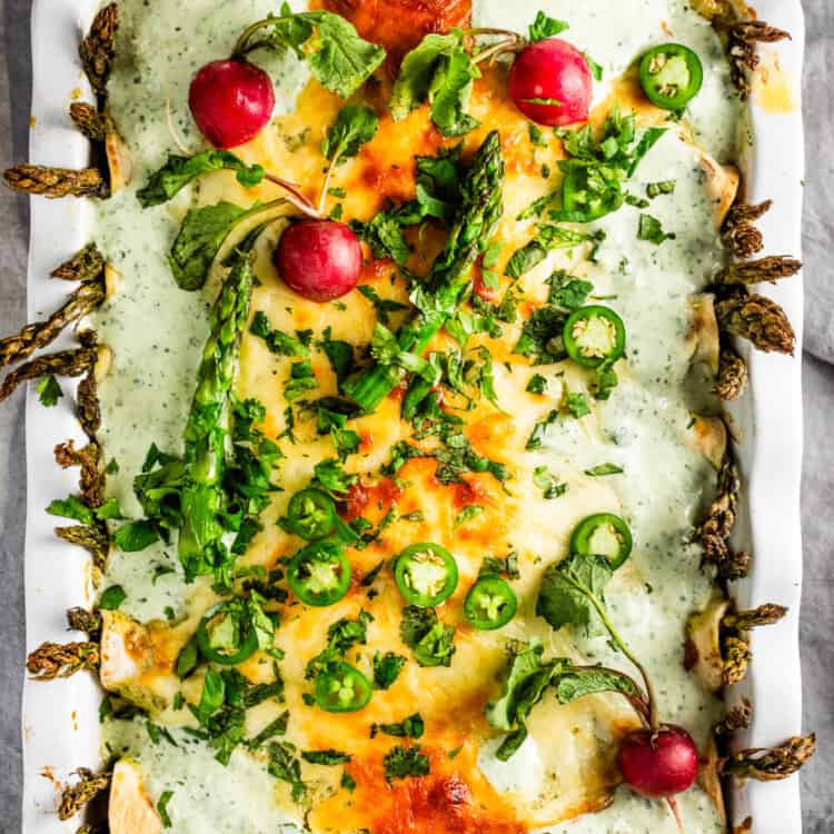 A pan of Spring Enchiladas with radishes and asparagus
