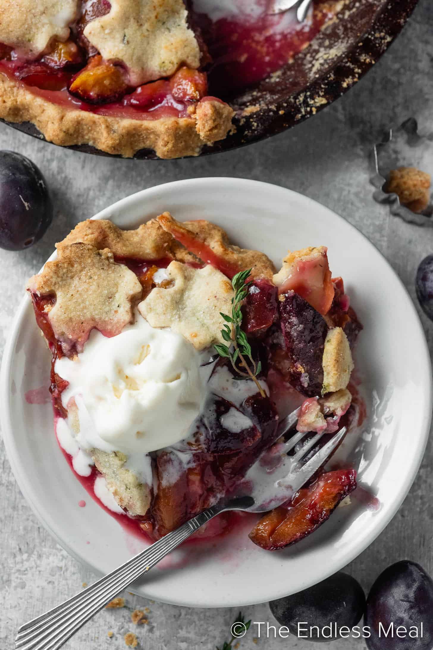 prune plum pie in a dessert bowl with ice cream