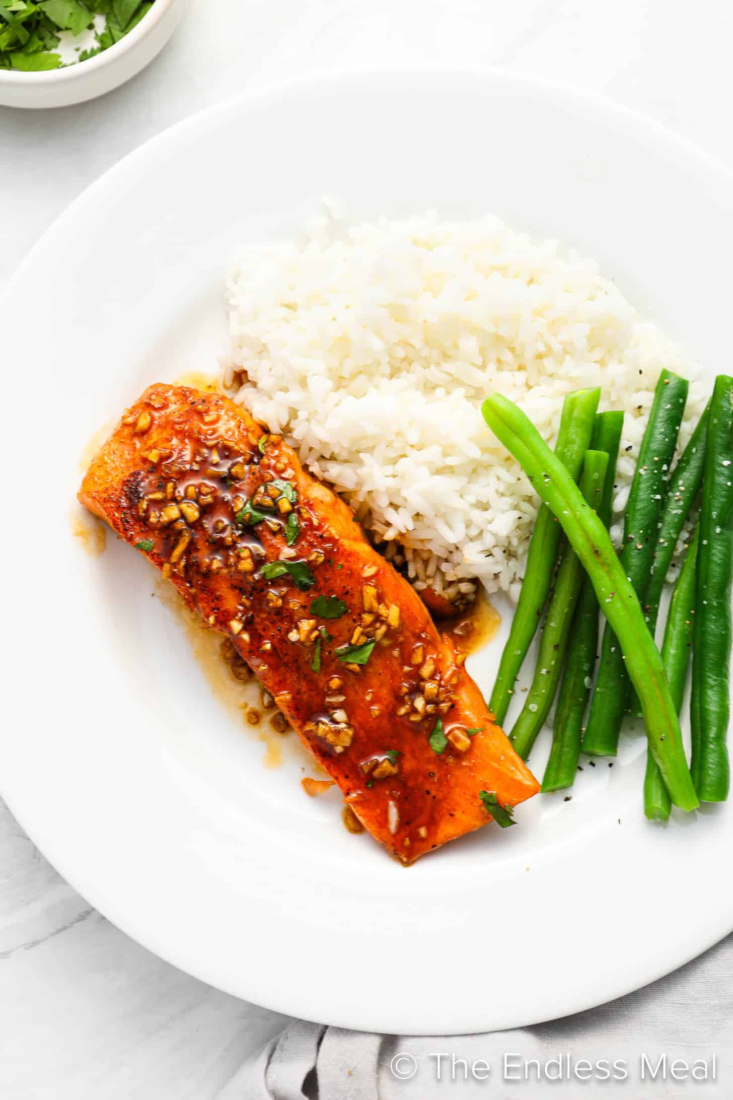 Honey Glazed Salmon on a dinner plate with rice and beans
