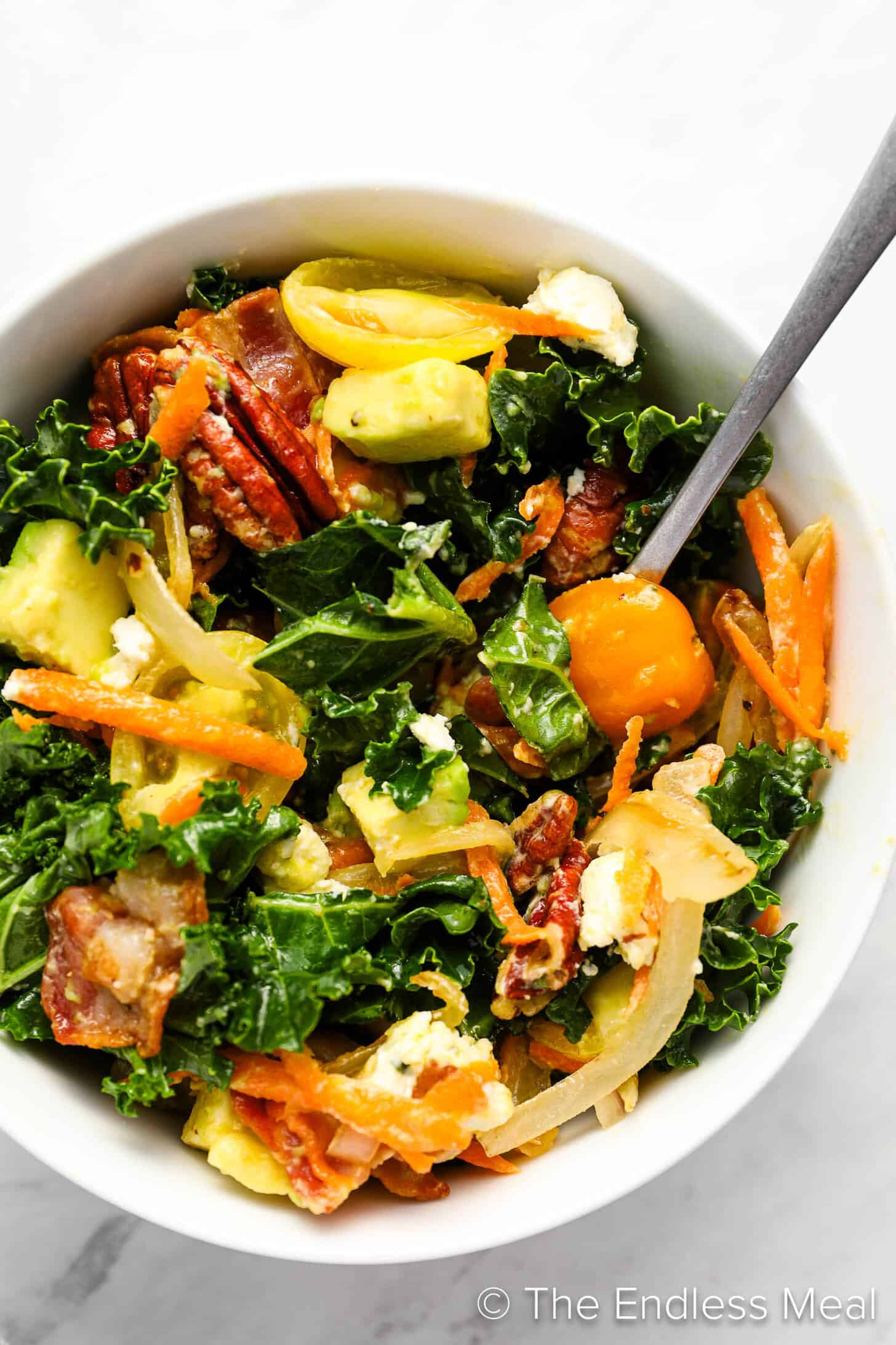 Kale Salad in a dinner bowl with a fork