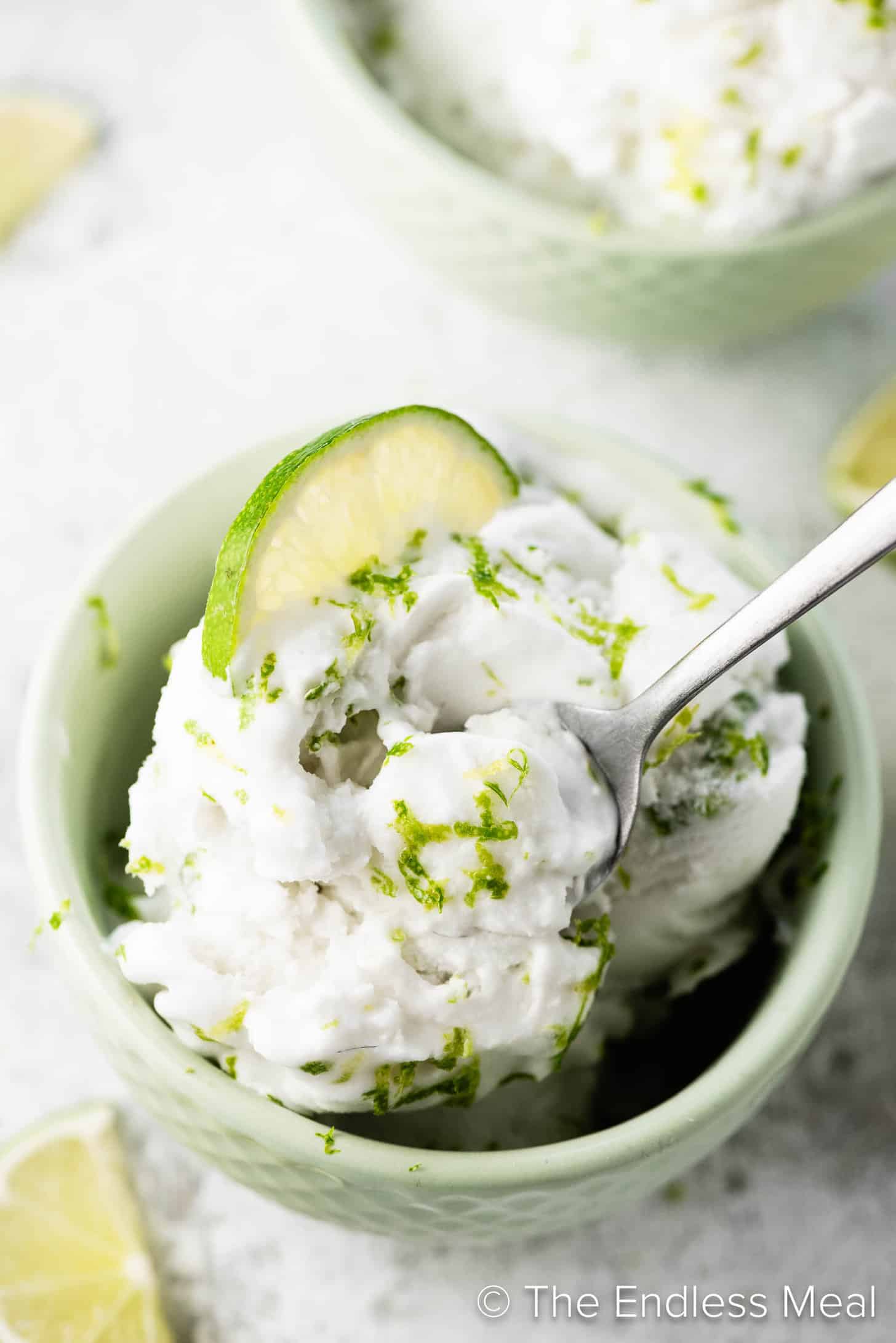 A spoon taking a scoop of Coconut Lime Ice Cream