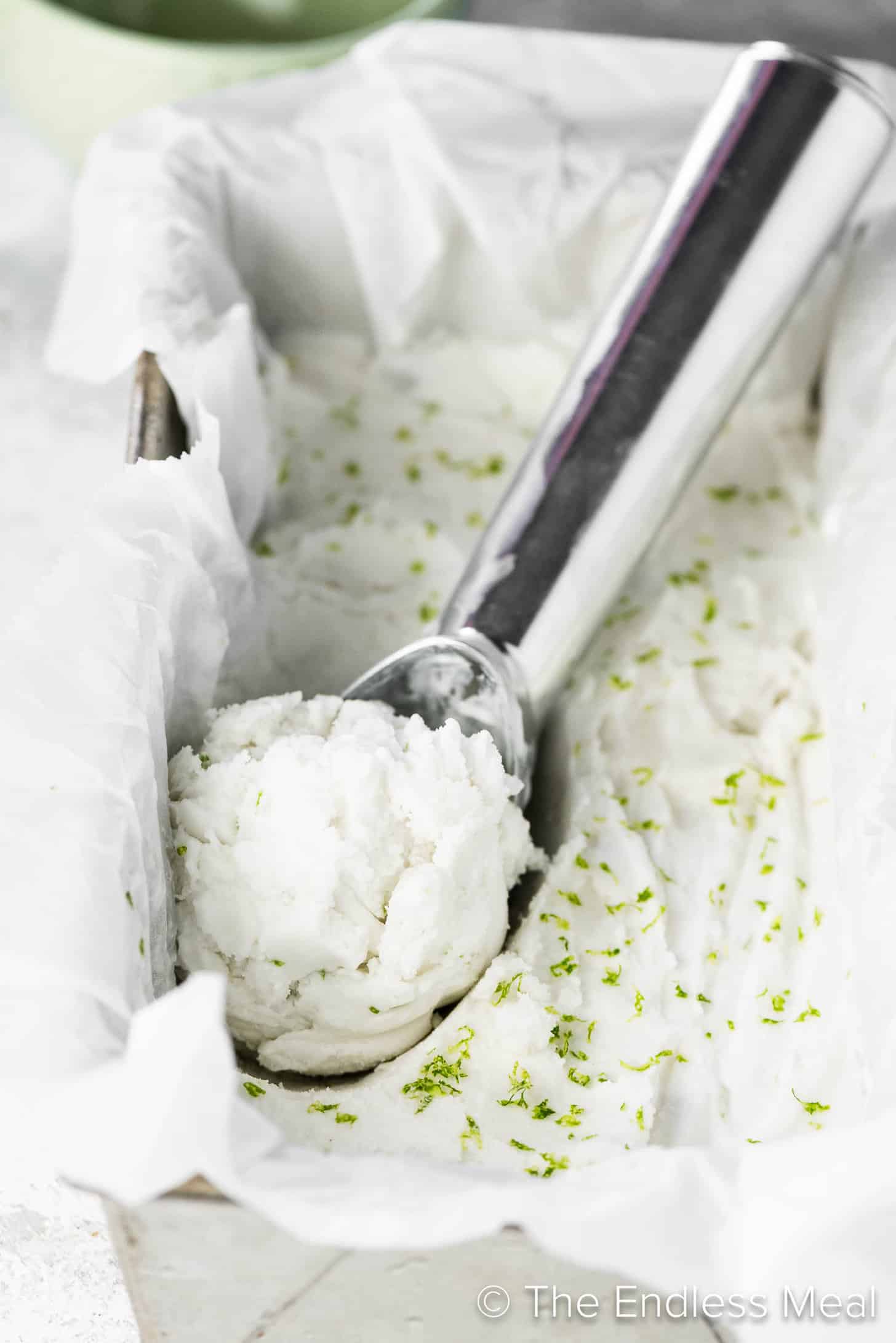 Coconut Lime Ice Cream with an ice cream scoop