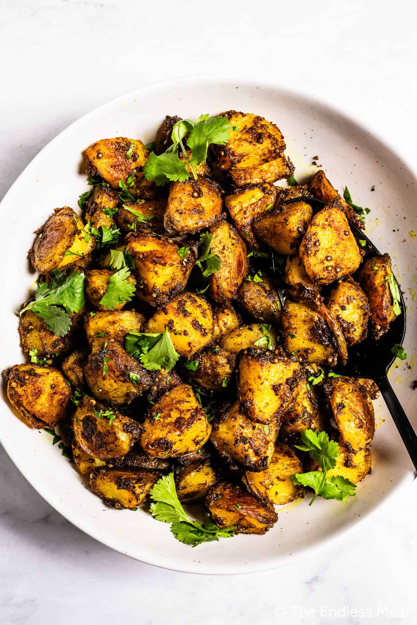 Bombay Potatoes in a dinner serving dish