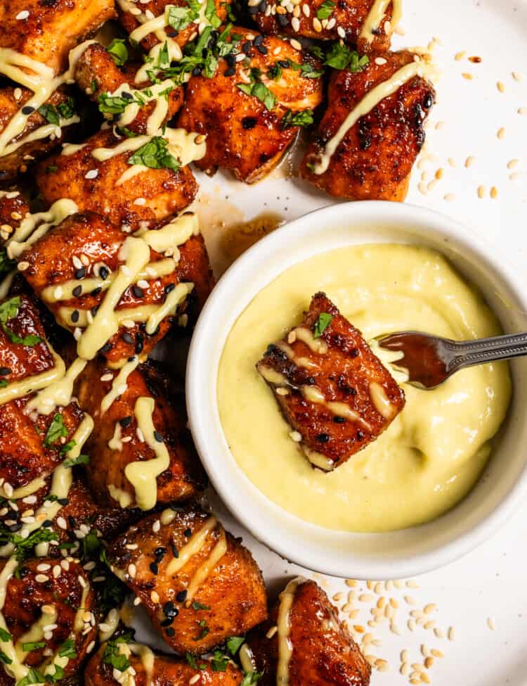 Wasabi Mayo in a bowl on a plate of salmon bites.