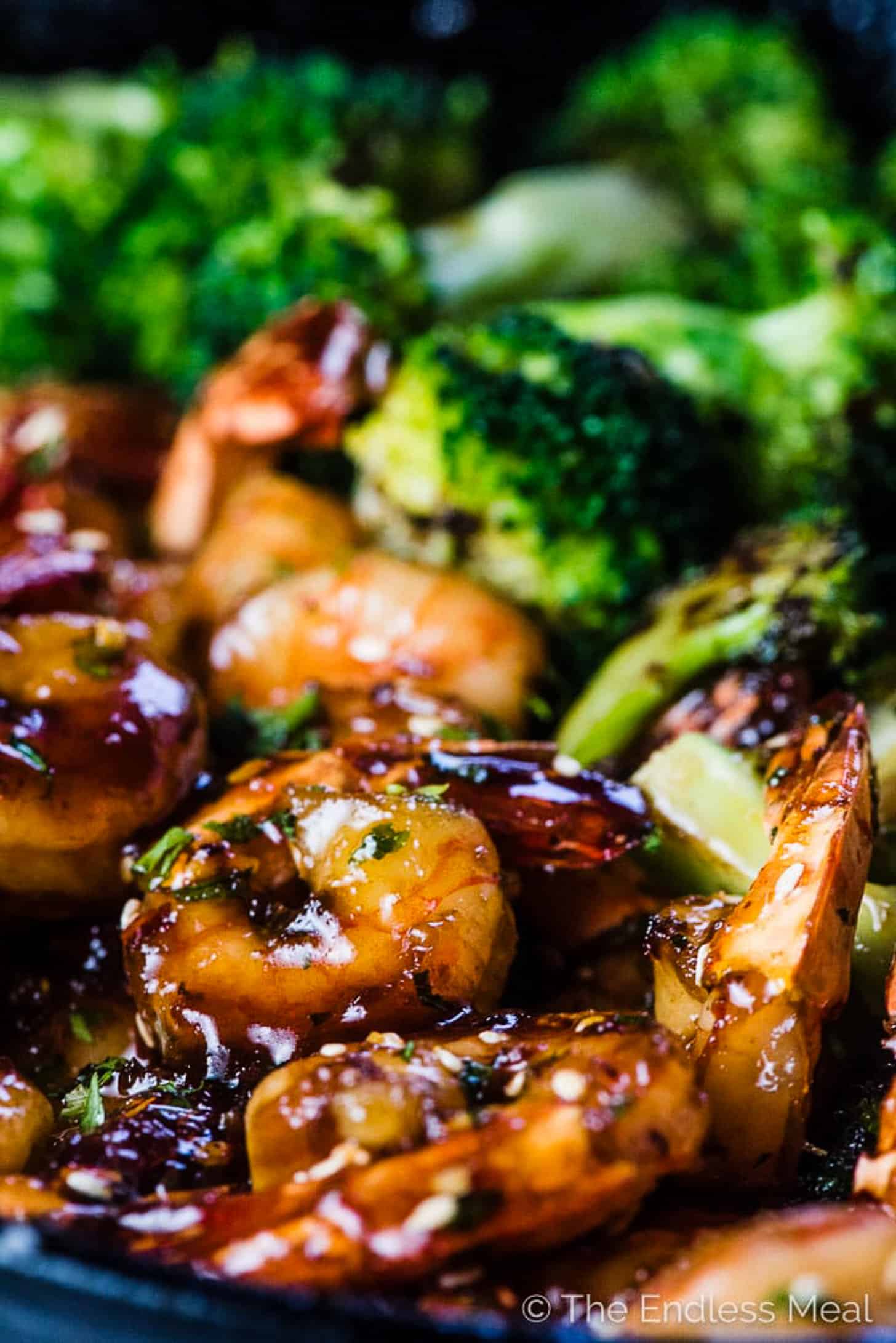 Honey Sesame Shrimp cooking in a pan with broccoli