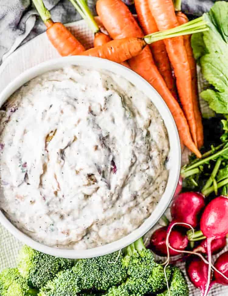 Roasted Onion Dip on a plate with veggies