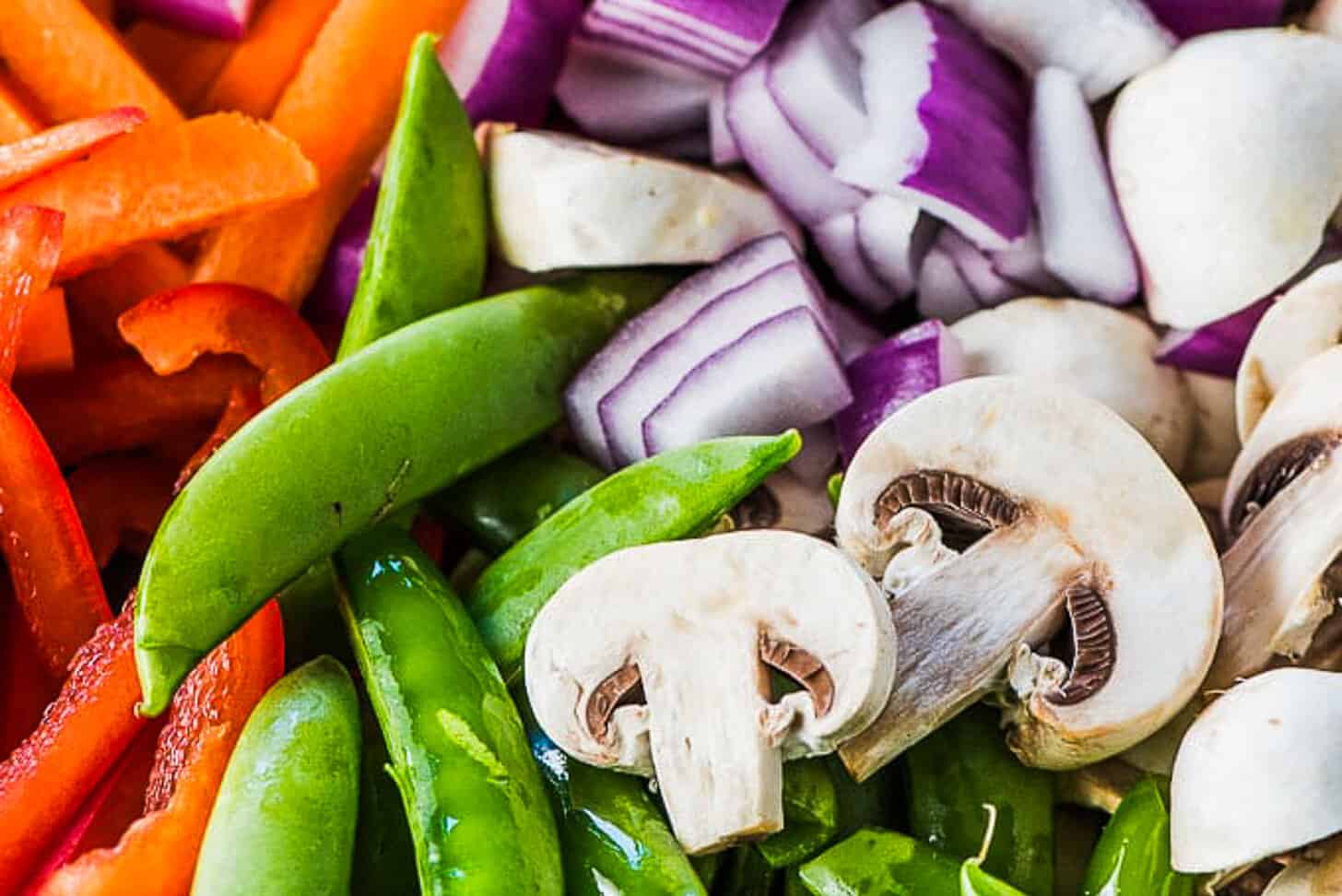 a close up of chopped stir fry veggies