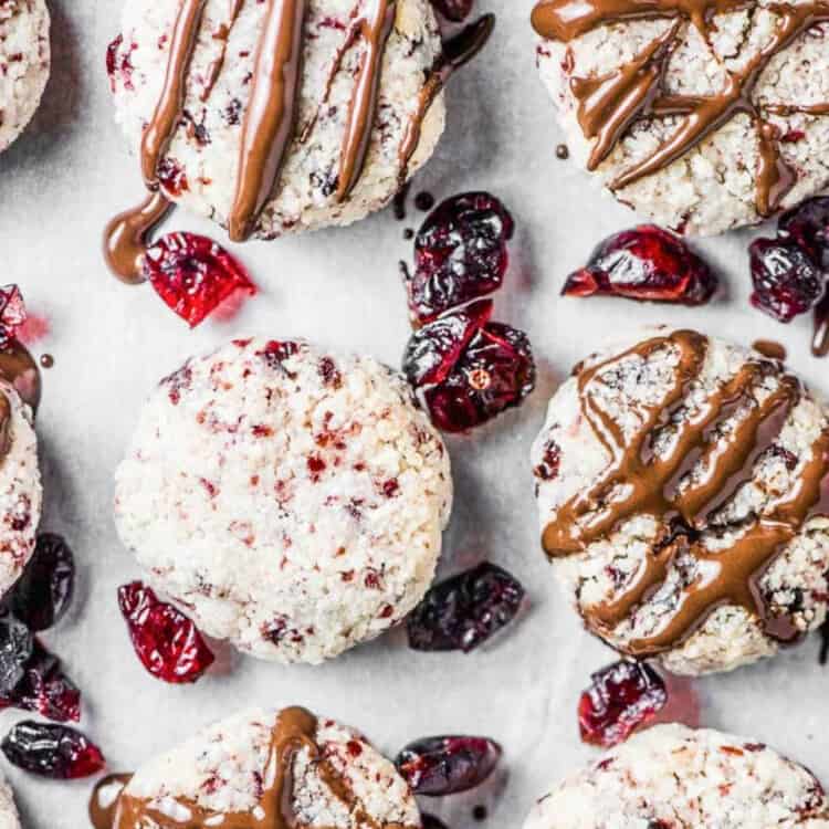 Cranberry Coconut Macaroons being decorated on a baking sheet