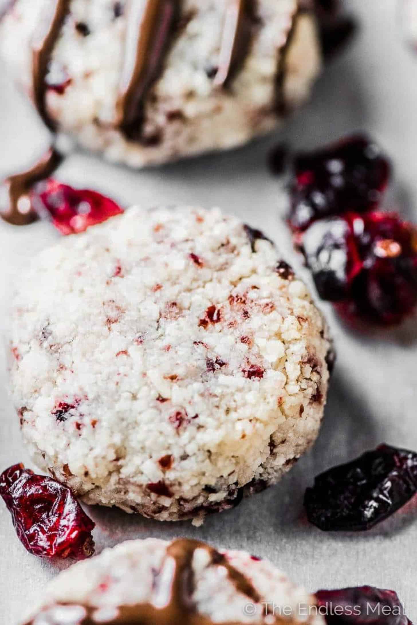 A close up of a coconut macaroon with cranberries
