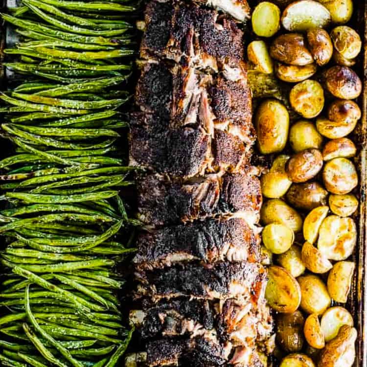 Baked ribs and potatoes with green beans on a sheet pan