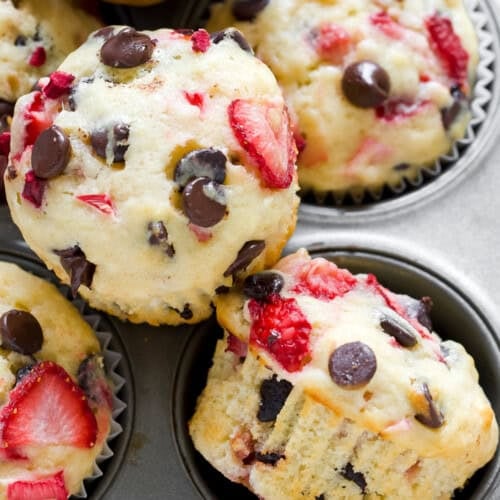 Enjoy these strawberry rhubarb muffin delights, packed with chocolate chips and chunks of strawberries and rhubarb, all freshly baked in a metal muffin tin.