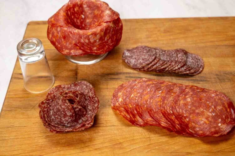 A group of sliced meat on a table arranged as a delightful Valentine's Charcuterie Board—perfect for sharing as a festive Valentine's Day snack.